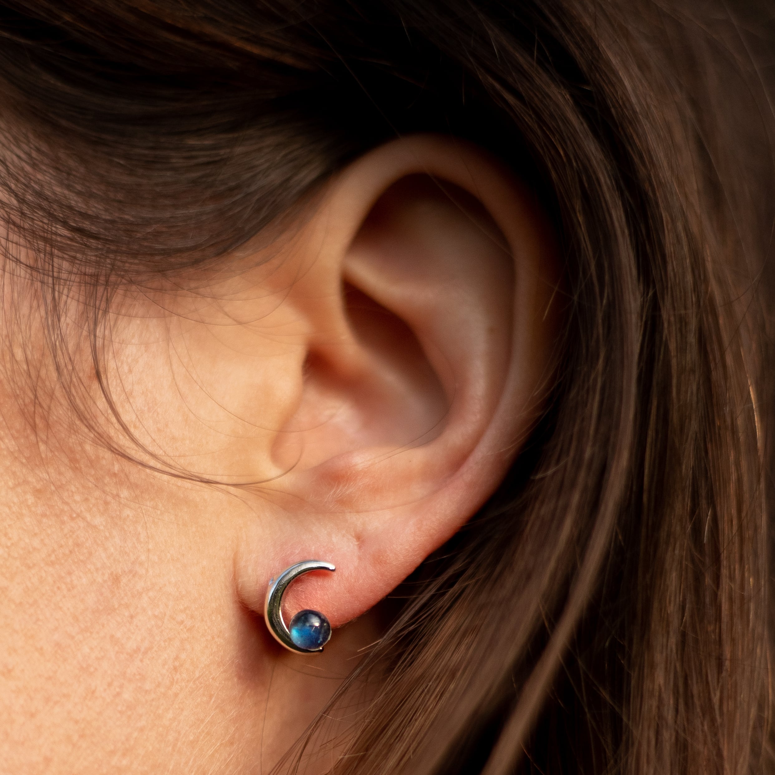 The "Moon Star" earrings displayed against a dark, starry background - KARMAKIND