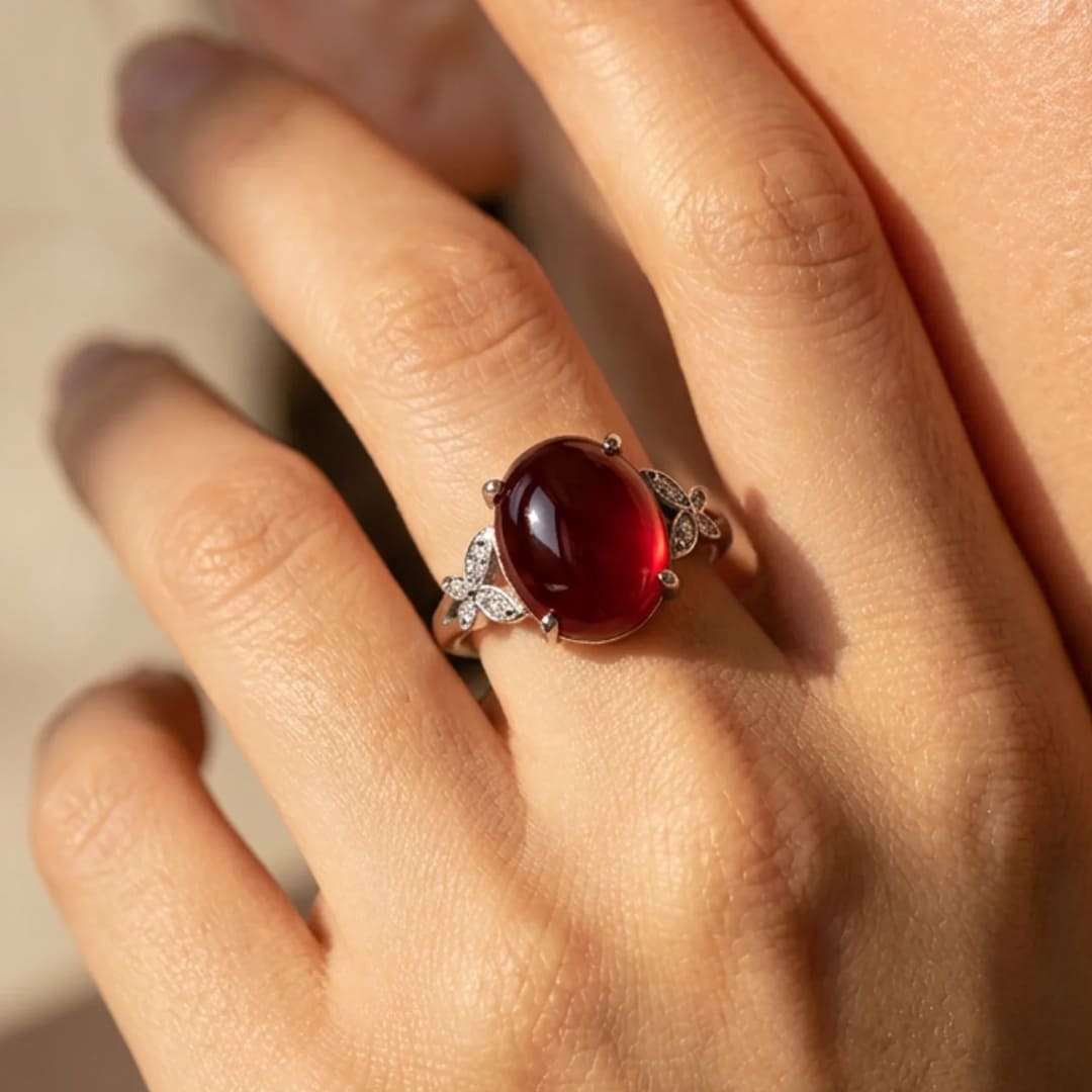 Close-up of the adjustable Garnet ring with butterfly details - KARMAKIND