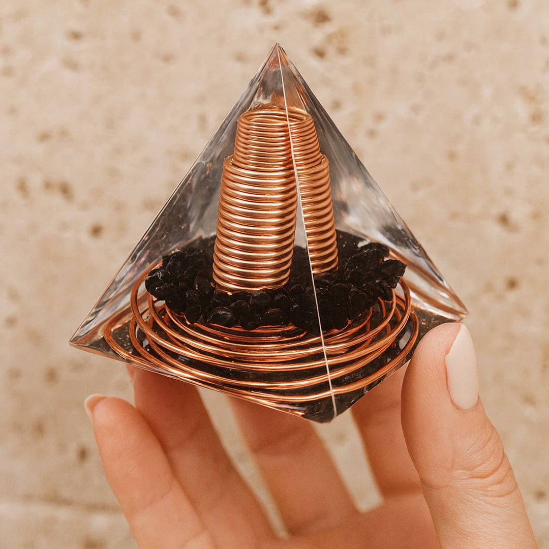 Close-up of obsidian shards and copper spiral within the orgonite pyramid - KARMAKIND
