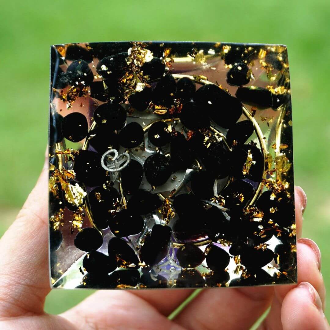 Black obsidian base with golden flecks evoking a night sky