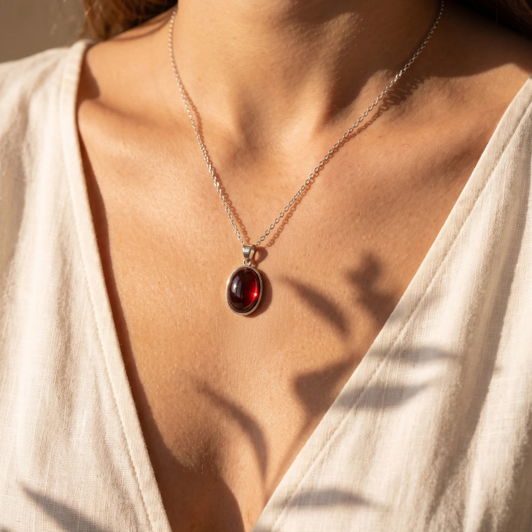 Close-up of the oval-shaped Garnet stone - KARMAKIND