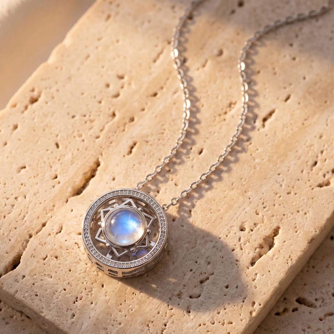 The moonstone pendant shown from the side, highlighting its rotation feature - KARMAKIND