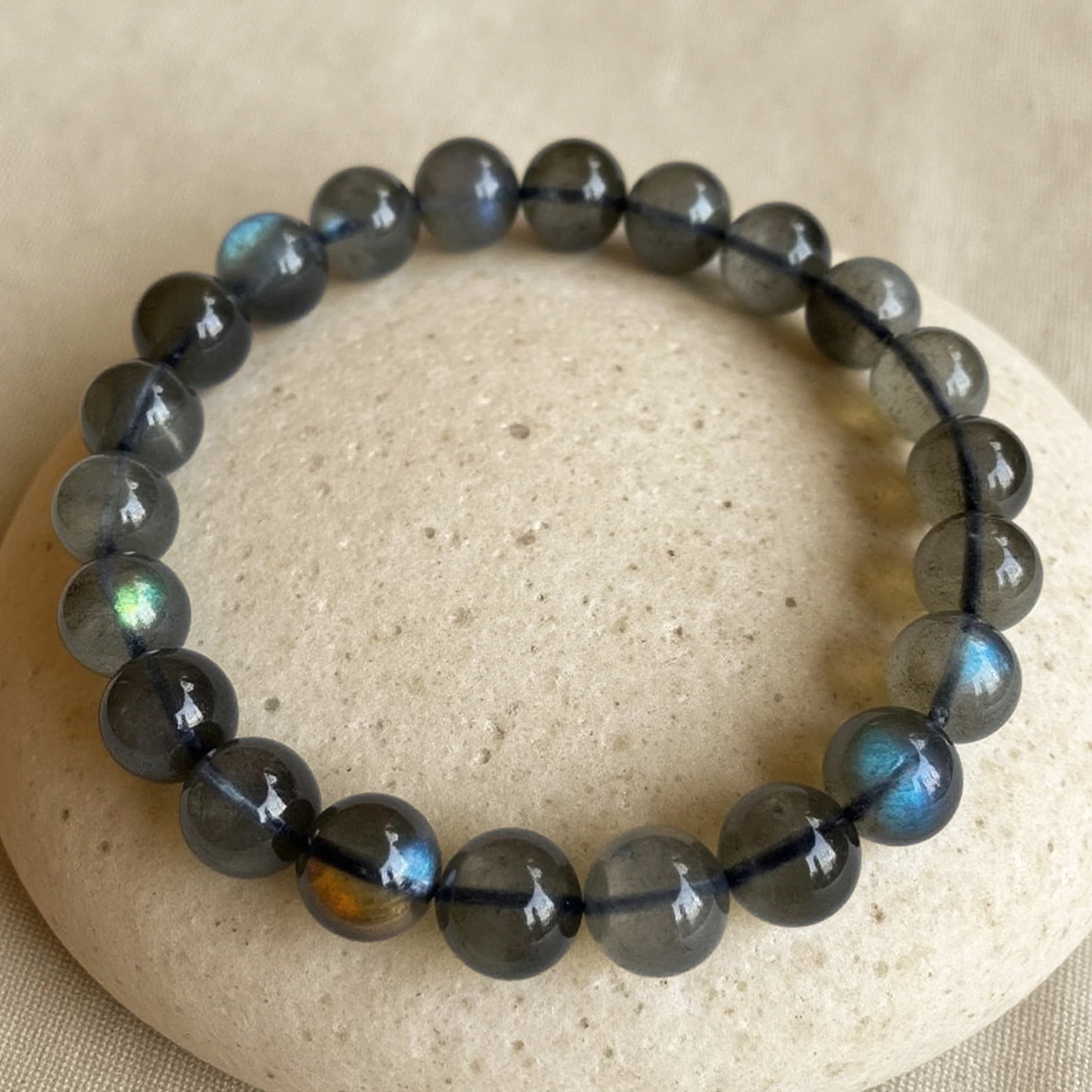 Labradorite Protection Shield Bracelet styled with a dark outfit - KARMAKIND