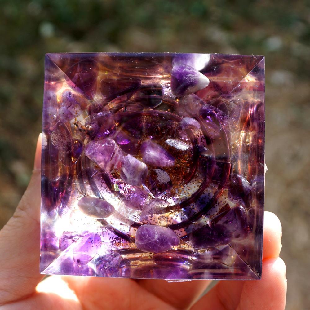 Golden halo detail surrounding the dark sphere in the Orgonite - KARMAKIND