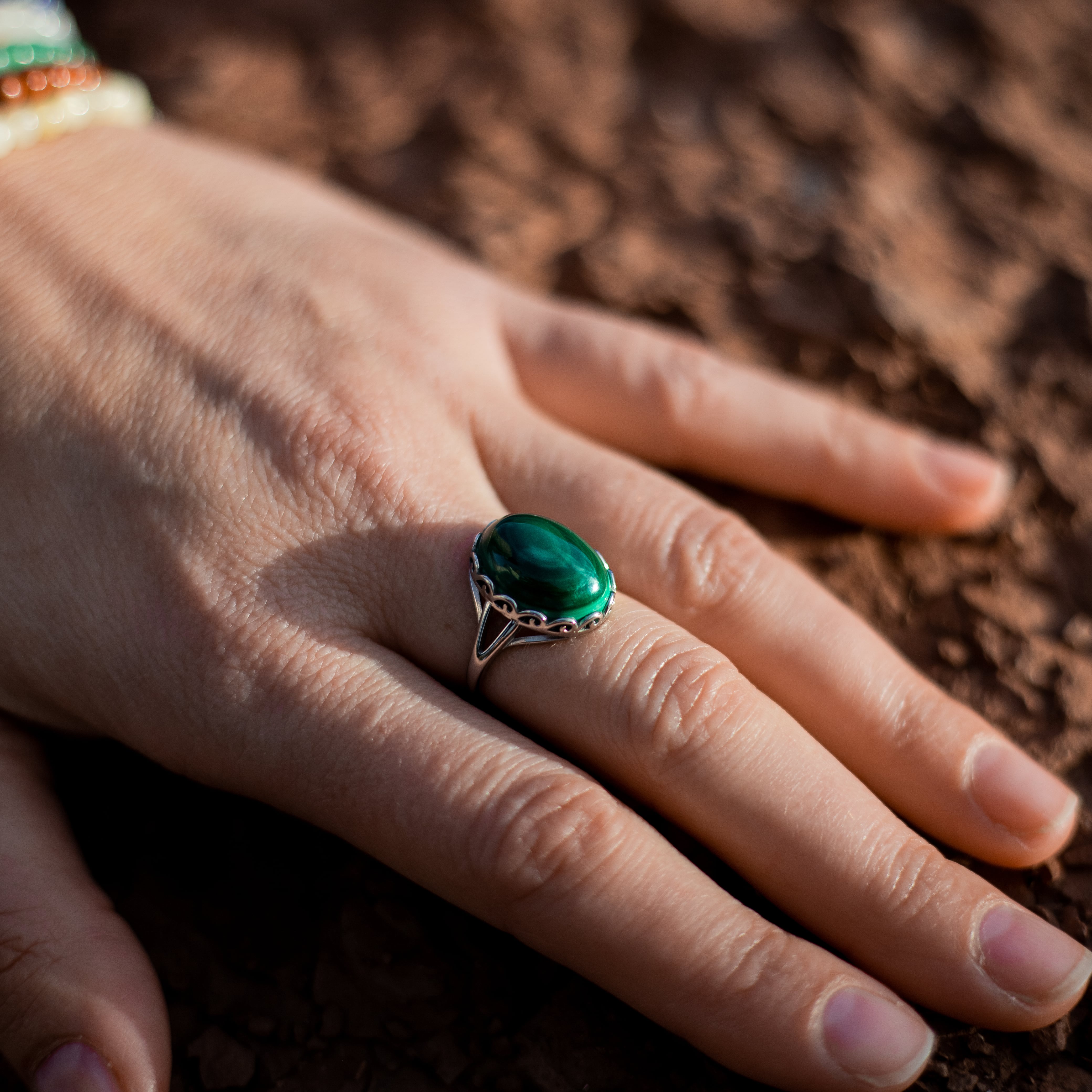 Lifestyle shot of the malachite ring reflecting nature's beauty - KARMAKIND
