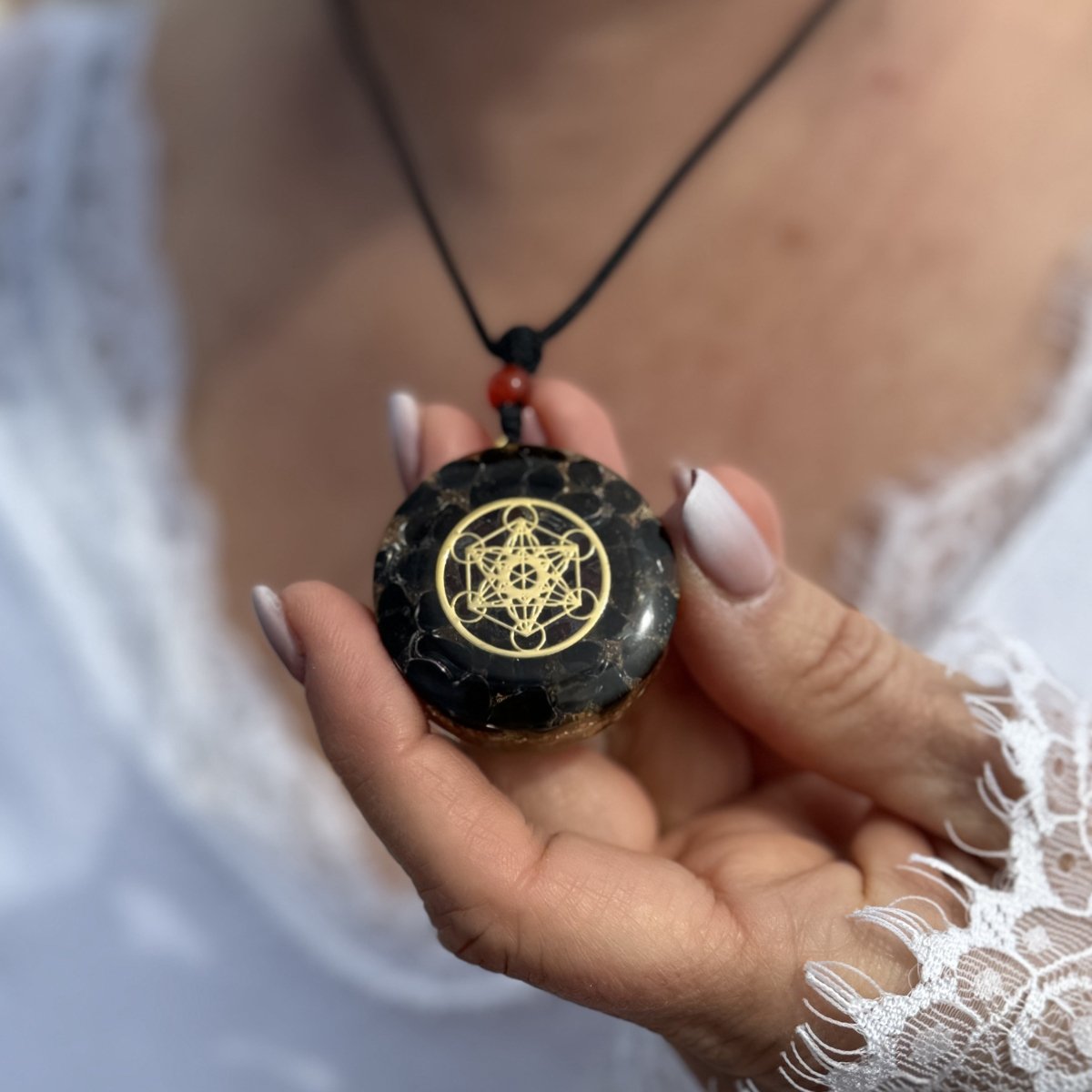 Close-up of the Metatron's Cube Orgonite Pendant showing the detail of obsidian and garnet - KARMAKI