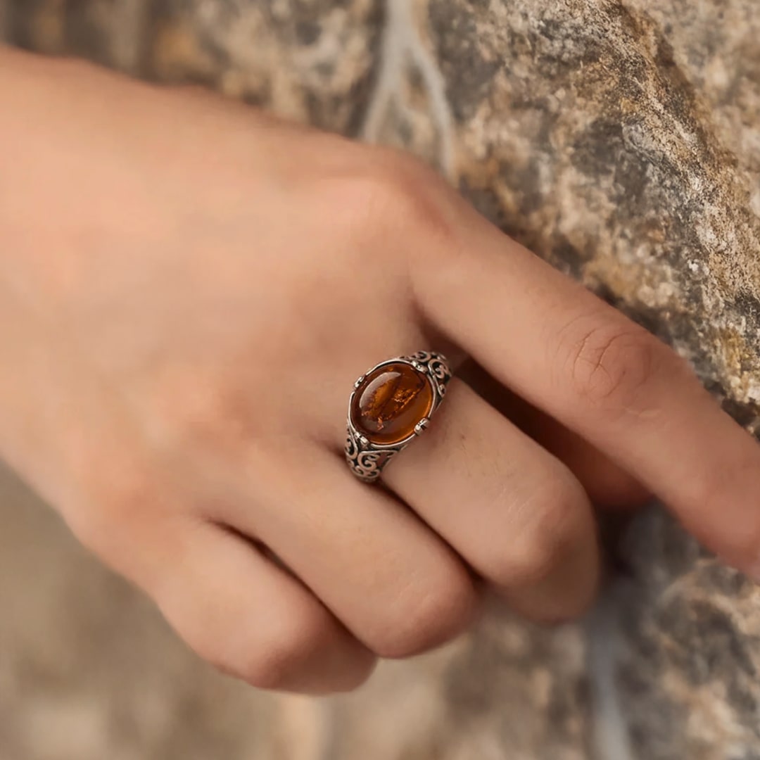 Woman's hand wearing the adjustable amber ring - KARMAKIND
