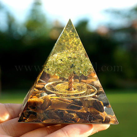 Peridot gemstones forming a tree shape in the orgonite