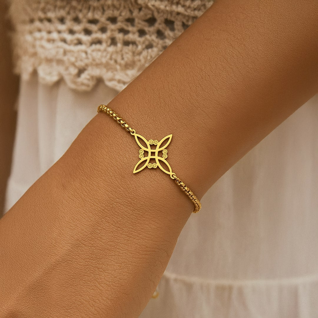 Close-up of the intricate Witch's Knot charm on the bracelet
