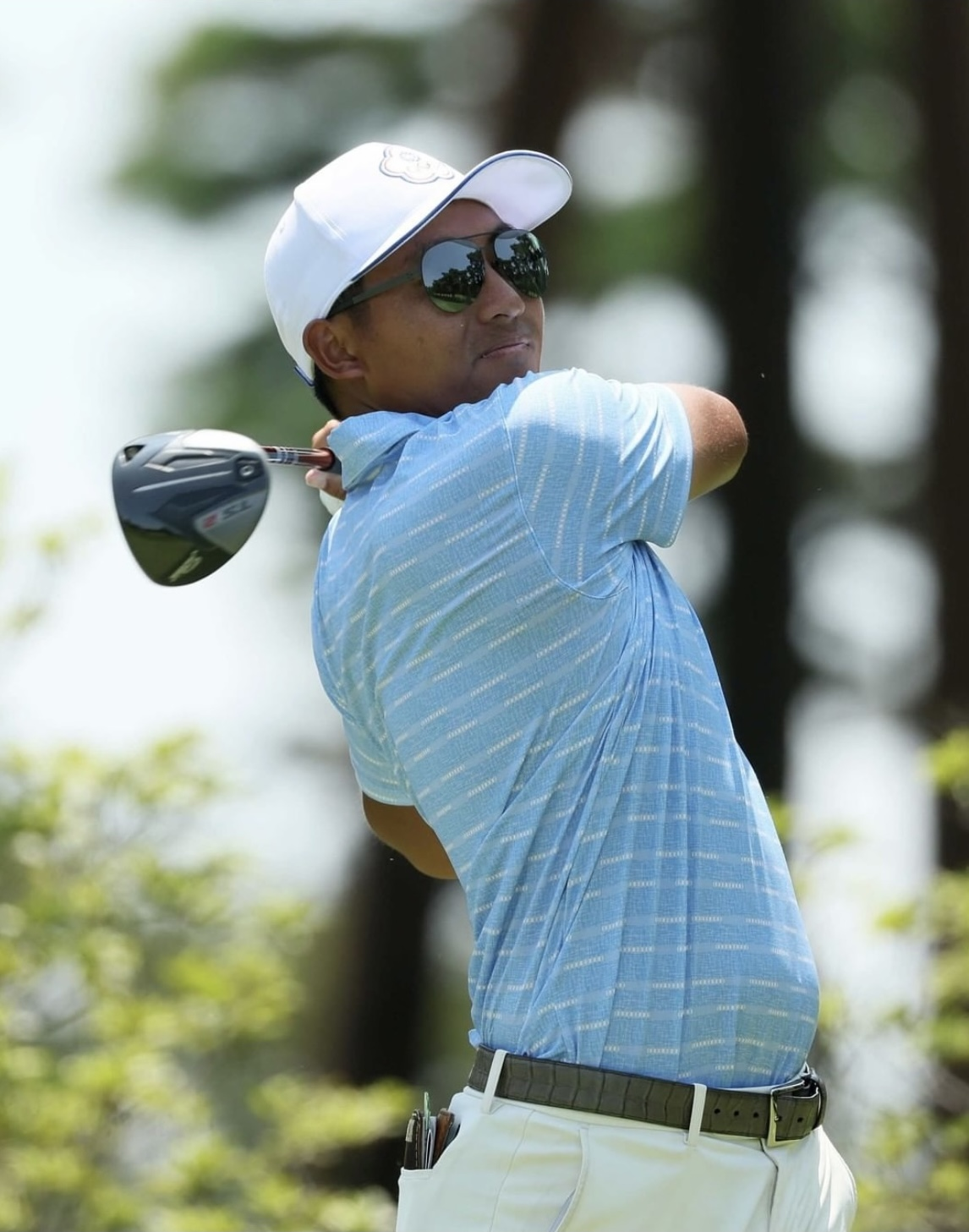 C.T. Pan wearing USWING signature sunglasses on the golf course