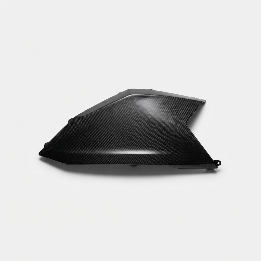 Black carbon fiber motorcycle side fairing panel on matte off-white background