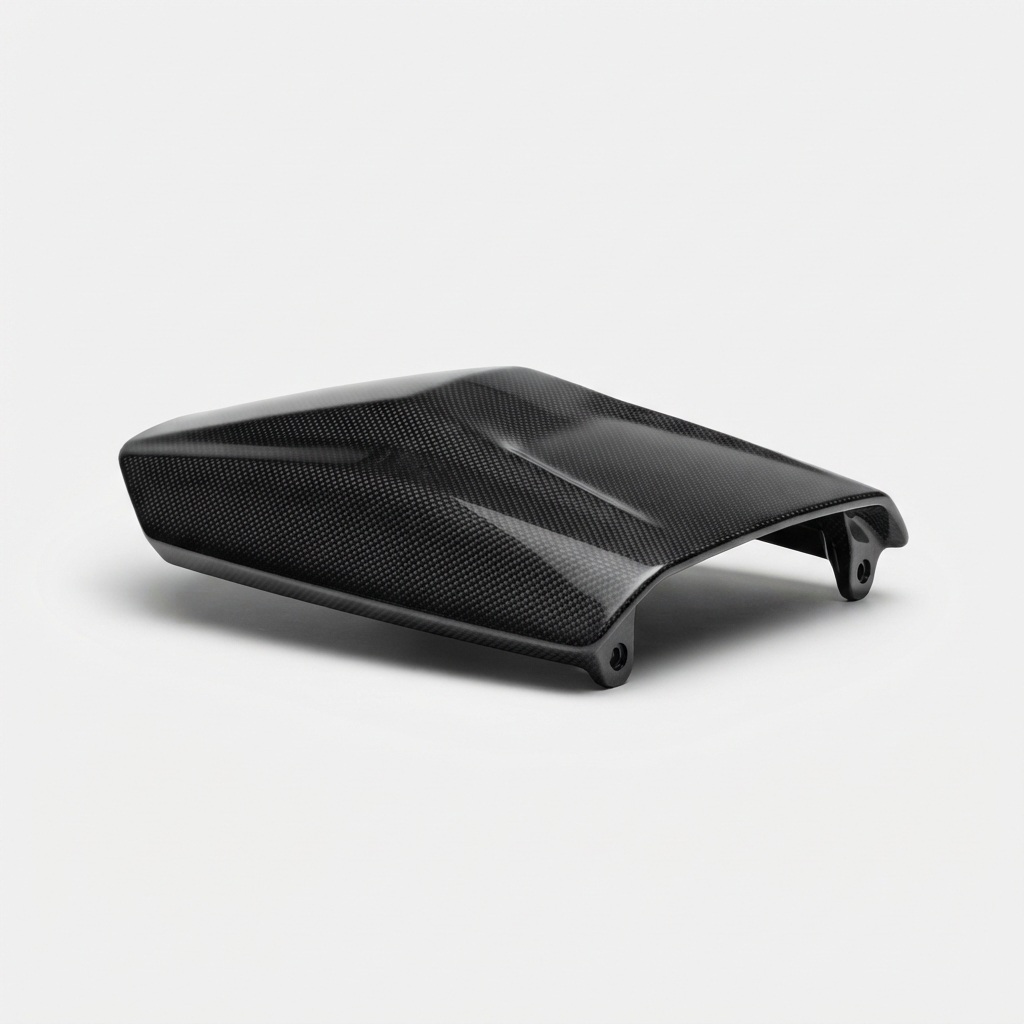 Black carbon fiber motorcycle rear seat cowl on matte off-white background
