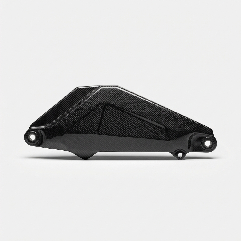 Black carbon fiber motorcycle chain guard on matte off-white background