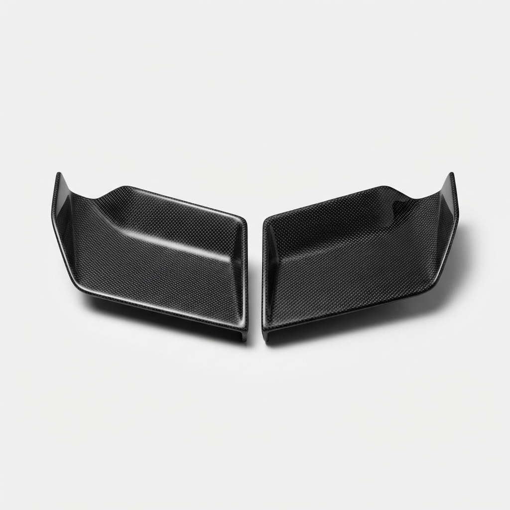 Black carbon fiber motorcycle aero winglet set on matte off-white background