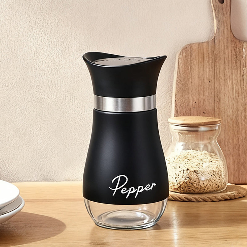 Curved black pepper shaker with stainless steel accent and clear glass base