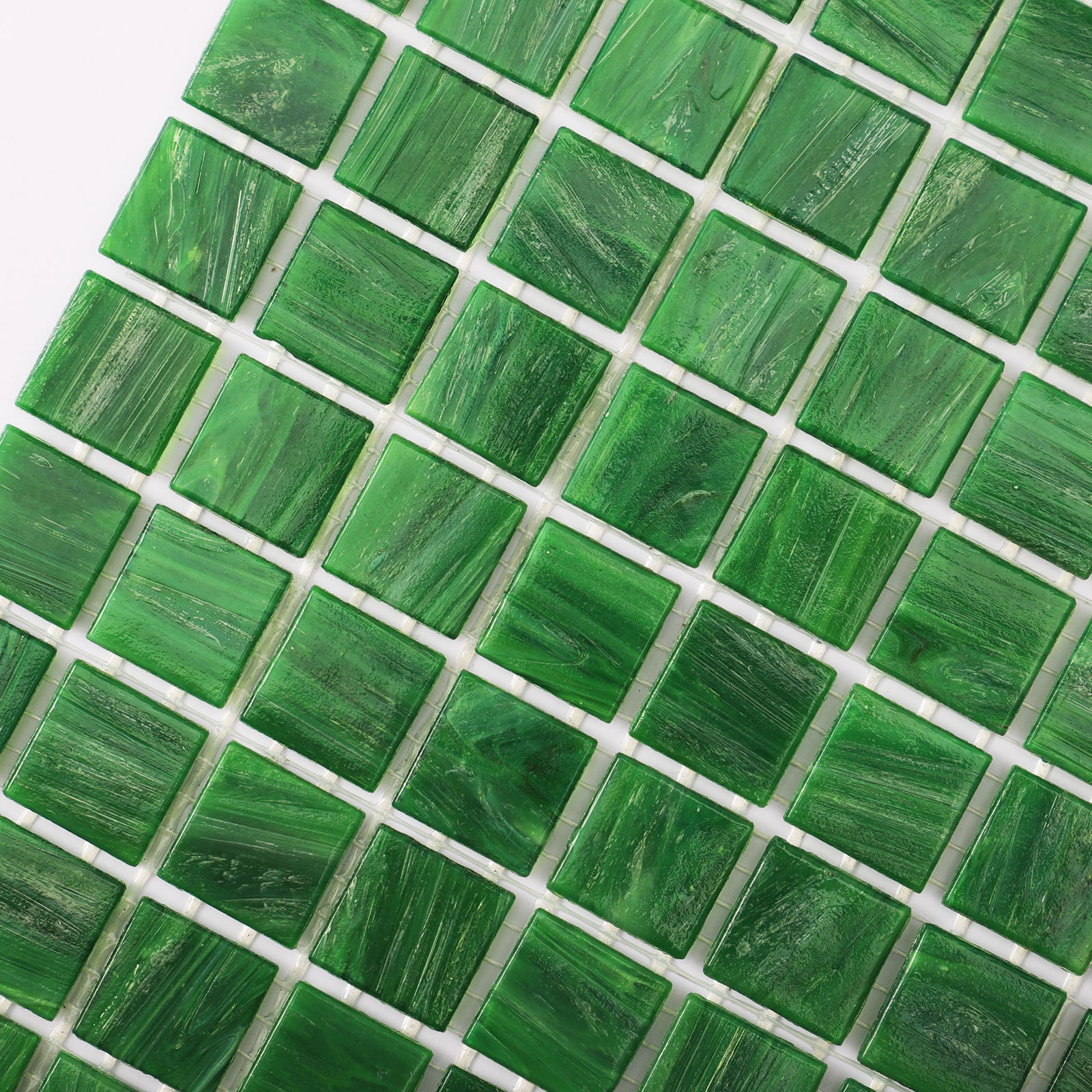 Green glass mosaic tiles with a glossy finish, arranged in a geometric pattern.