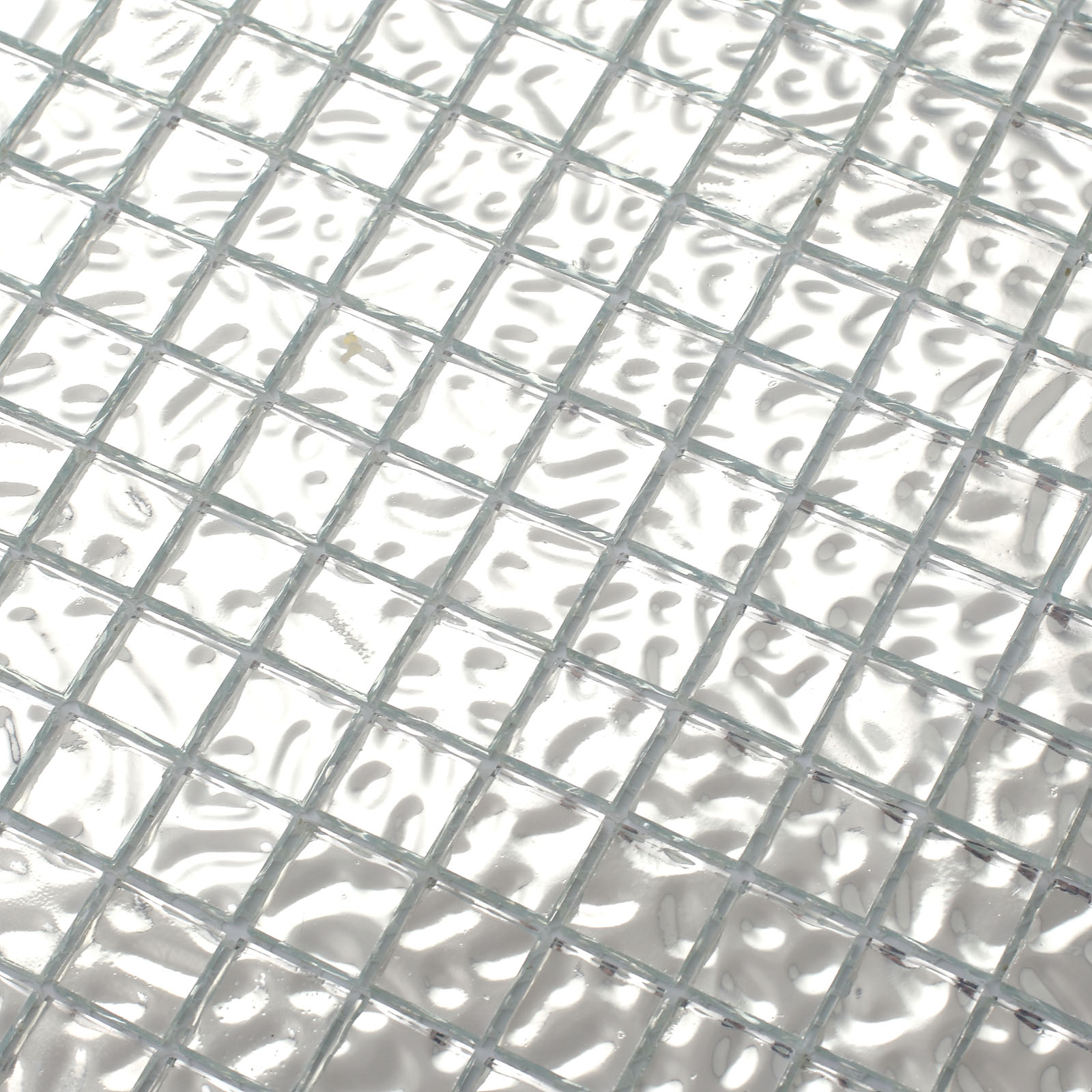 Close-up of silver glass mosaic tiles with a platinum finish.