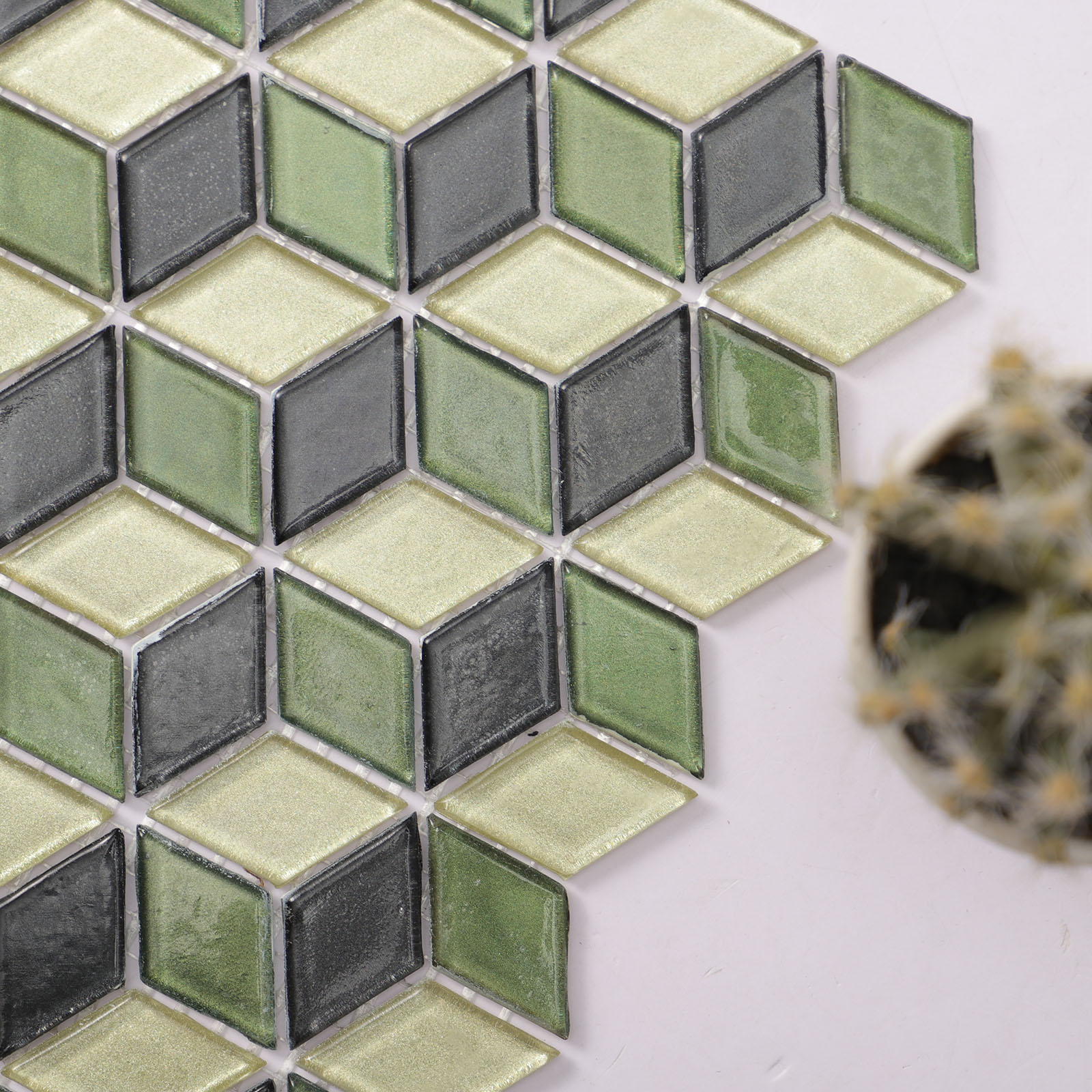 Close-up of 3D cube diamond green mosaic tiles with intricate design

