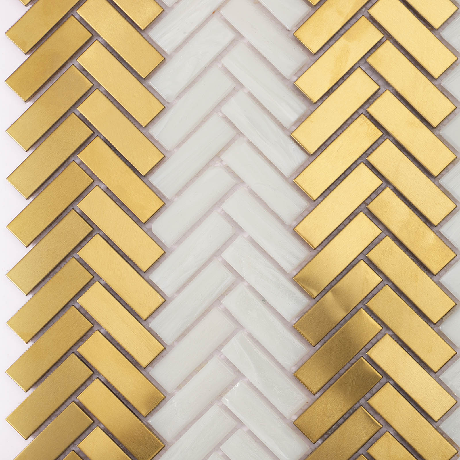 Close-up of herringbone glass and metal mosaic tiles with mixed textures.