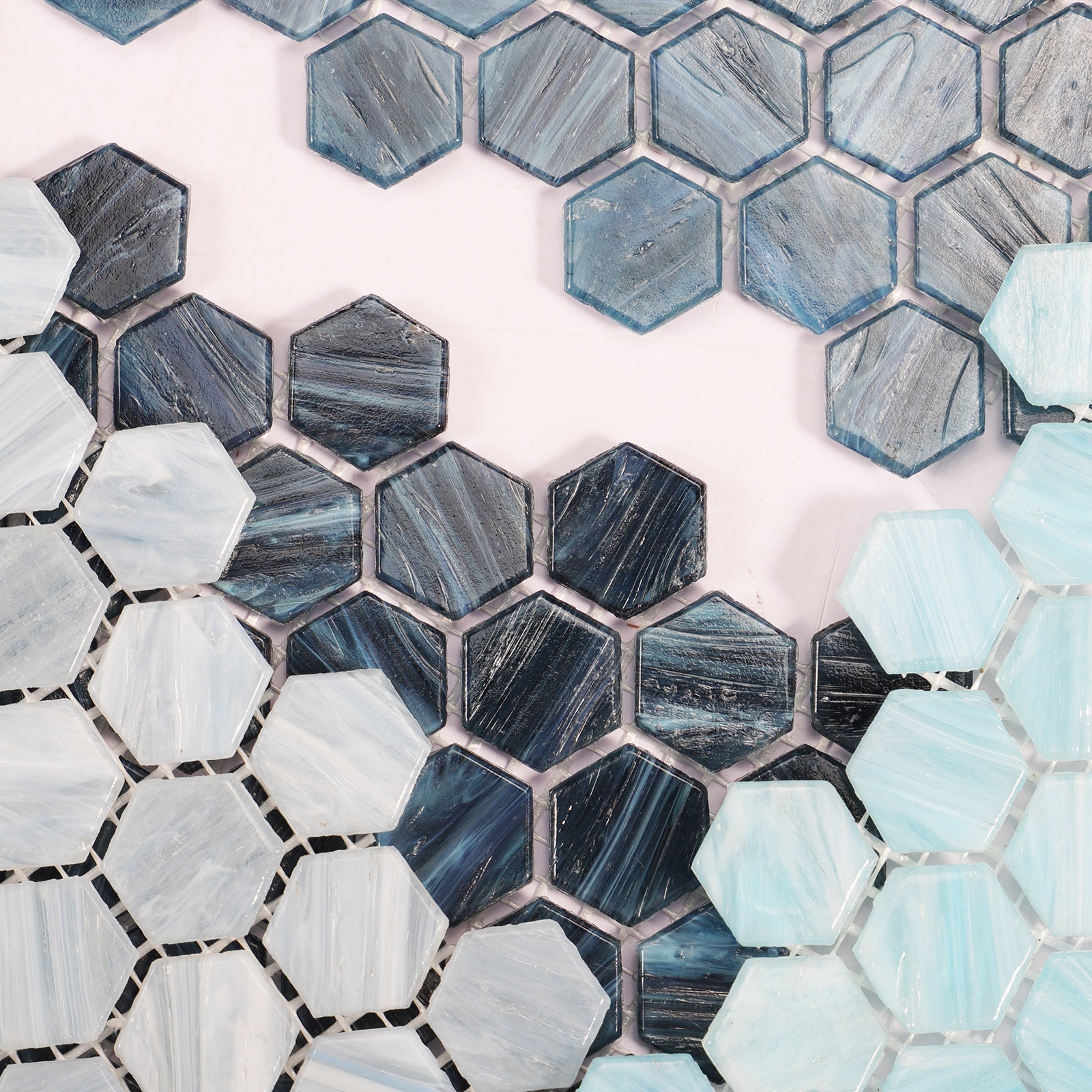 Close-up of multicolored hexagon glass mosaic tiles with vibrant patterns.