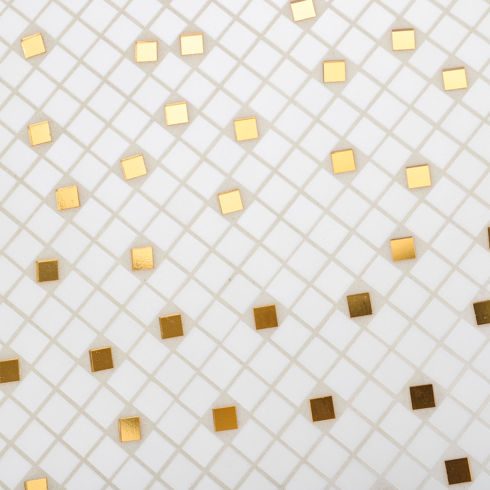 IClose-up of irregular gold and white mosaic tiles with unique shapes.