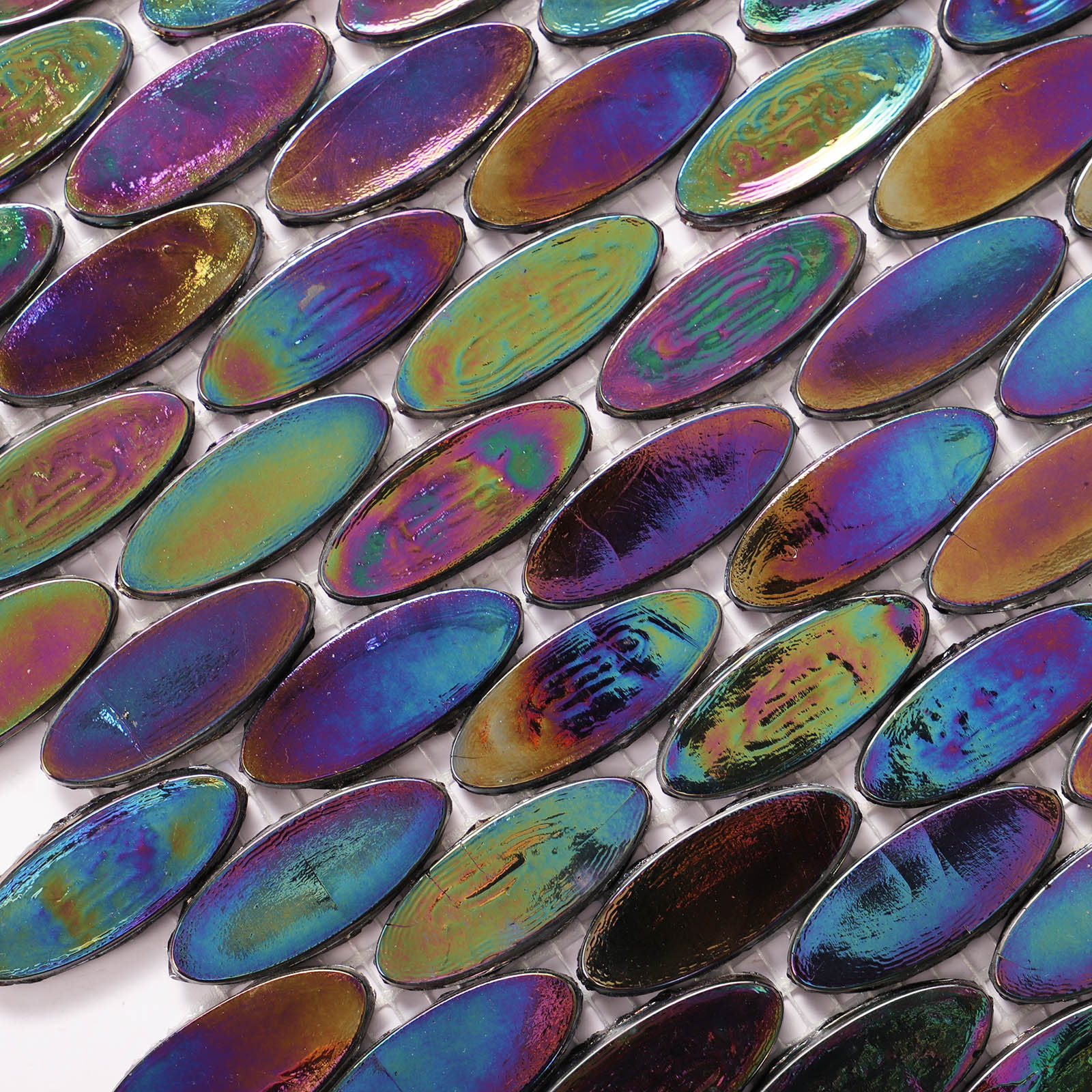 Close-up of oval iridescent glass mosaic tiles with shimmering colors.