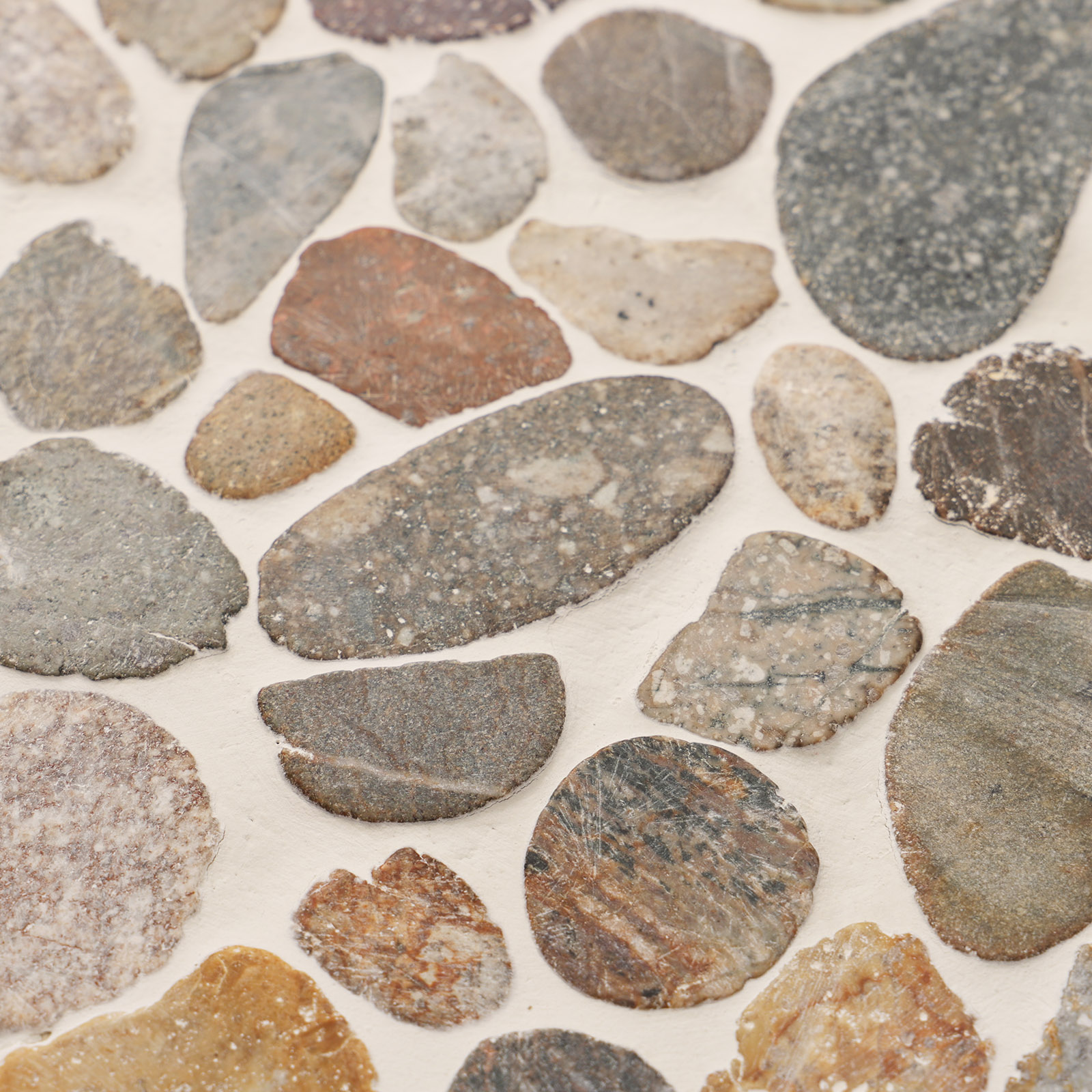 Close-up of river stone pebble mosaic tile with natural earthy tones.