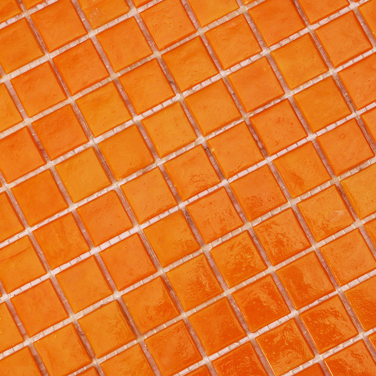 Close-up of orange glass mosaic tiles.