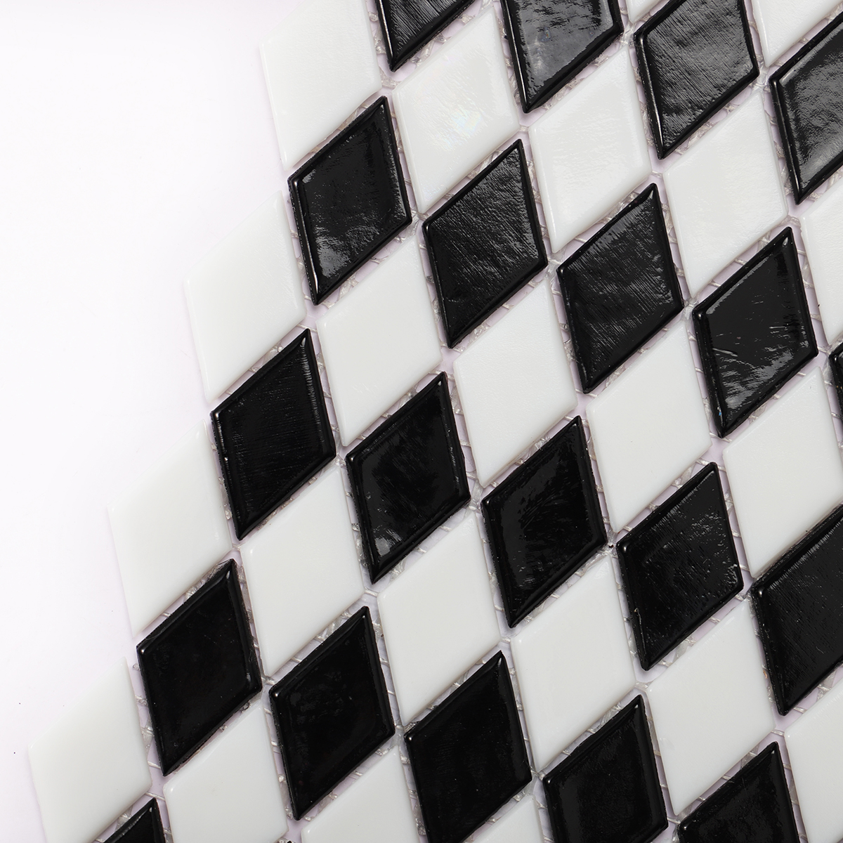 Detailed close-up of black and white checkerboard diamond glass mosaic tiles.