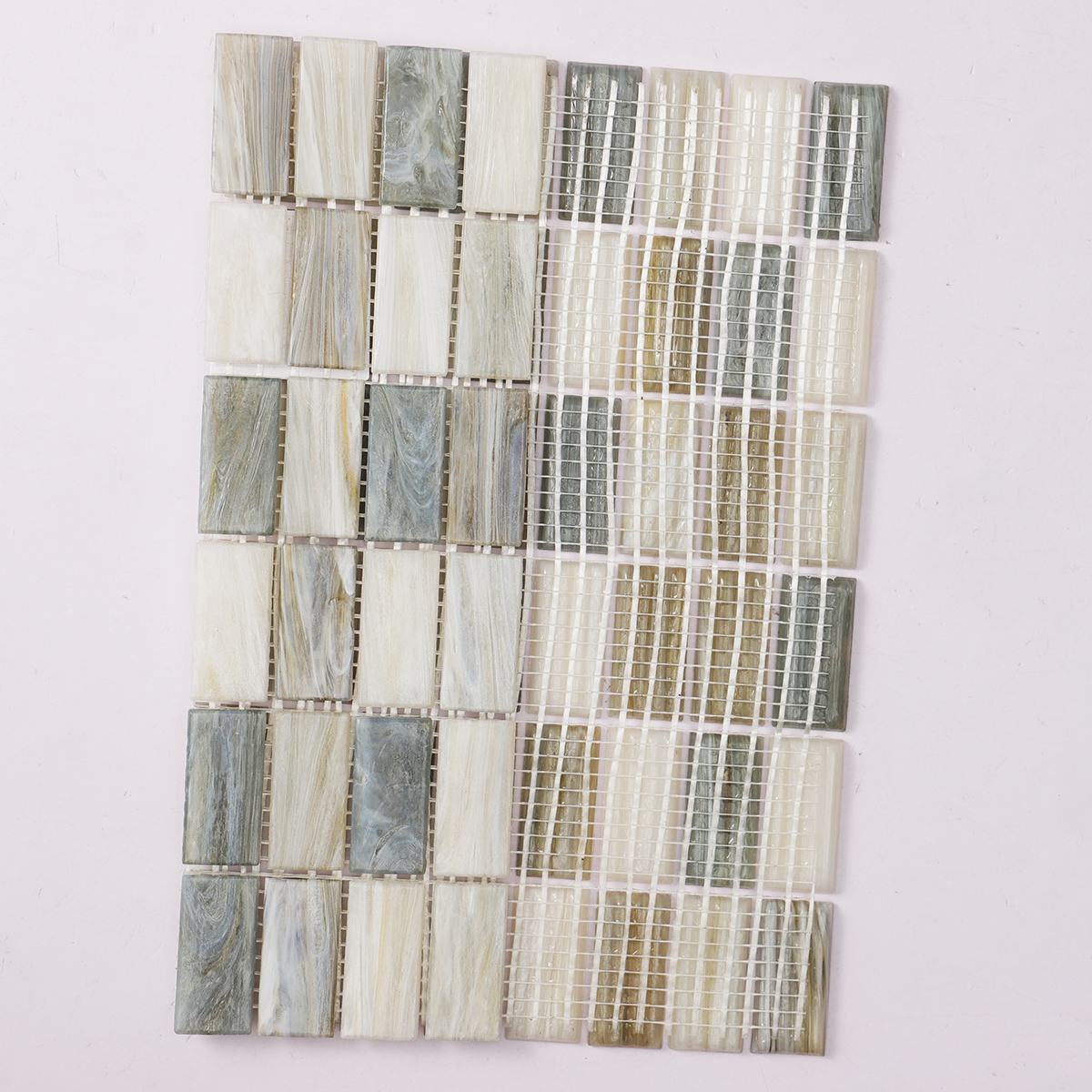 A sheet of rectangle beige multicolor glass mosaic tiles with a folded back.