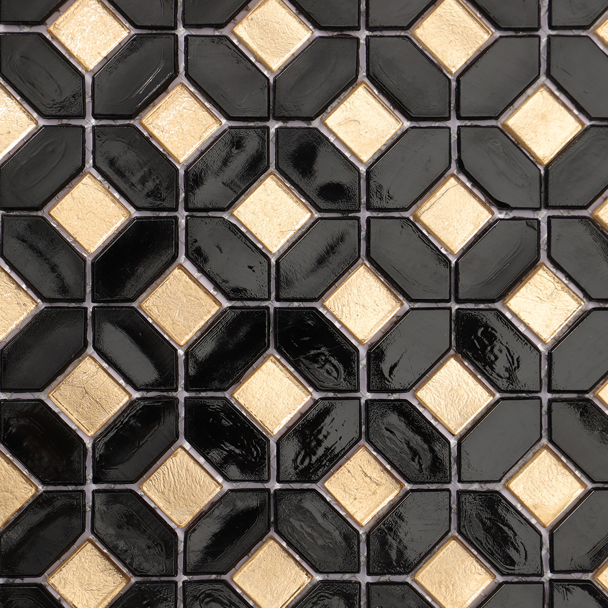 Close-up of black mini picket and square gold glass mosaic tiles.