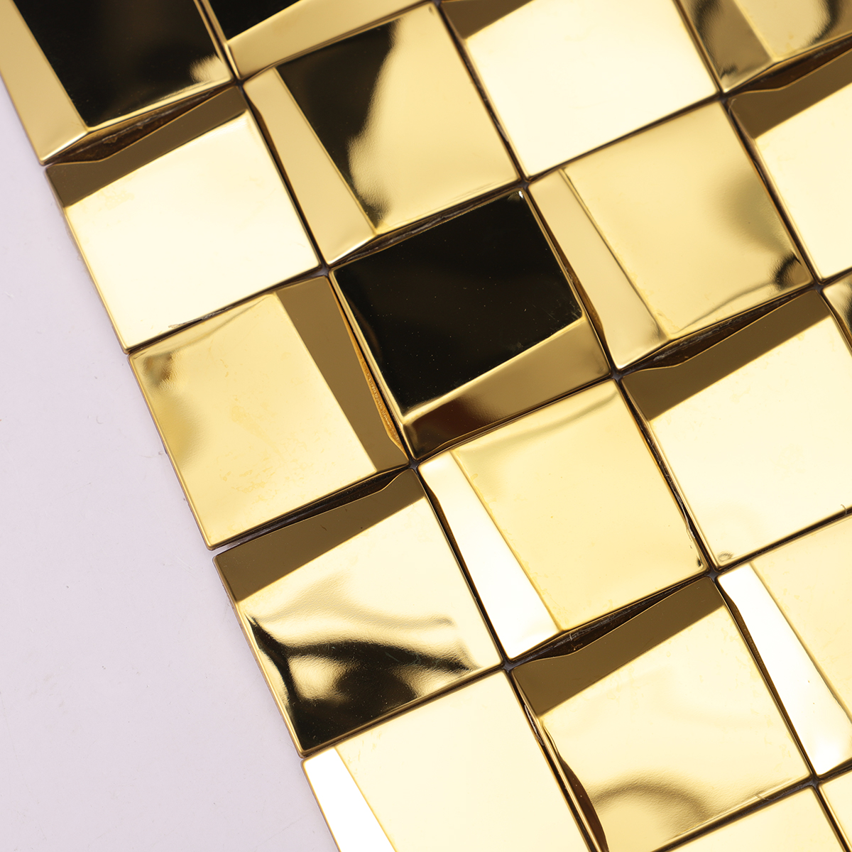 Close-up of gold 3D stainless steel square mosaic tiles