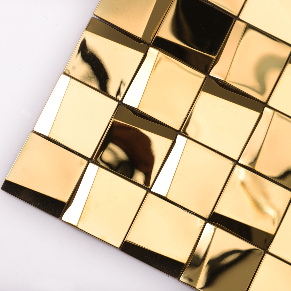 Detailed close-up of gold 3D stainless steel square mosaic tiles