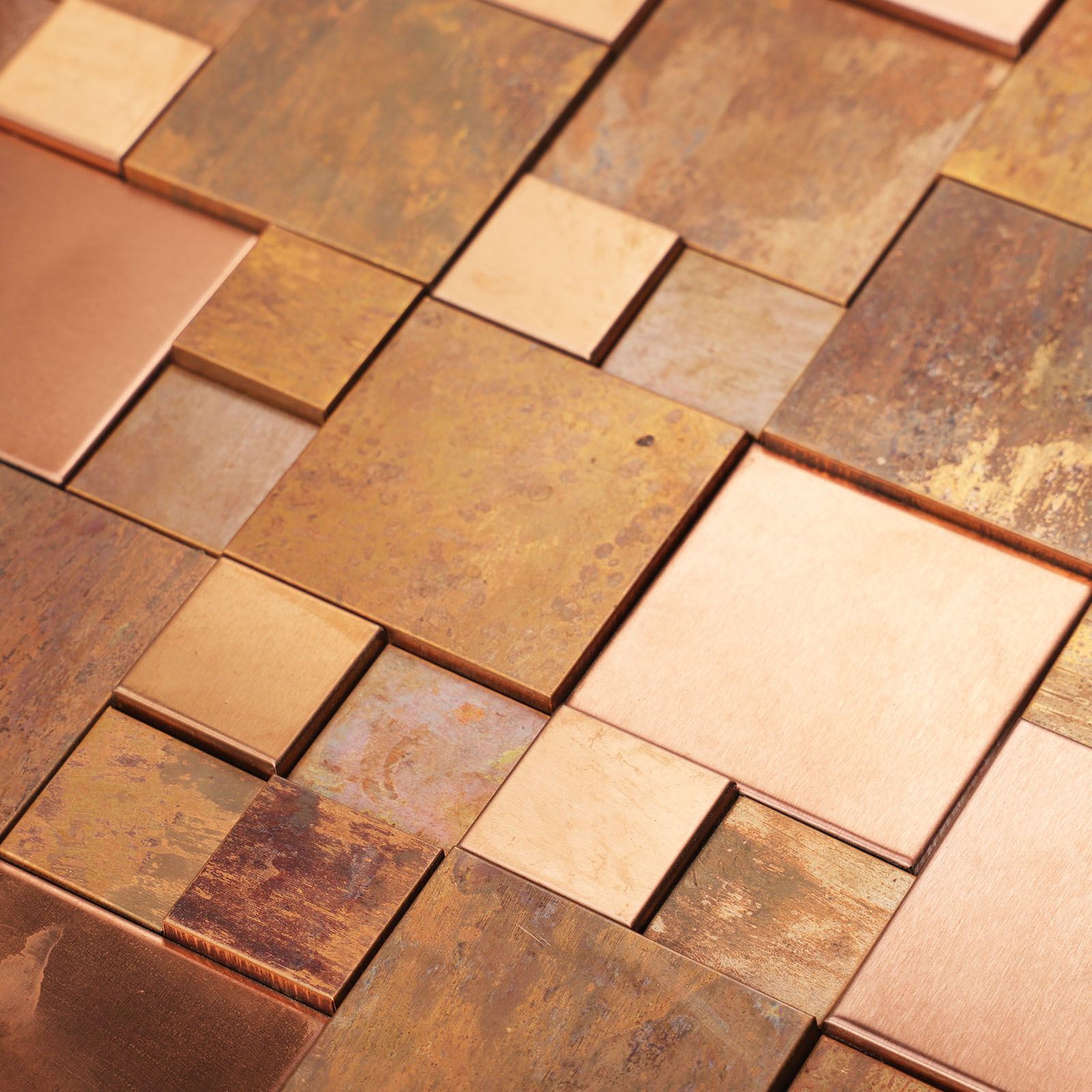 Close-up of 3D copper metal mosaic tile with textured surface.
