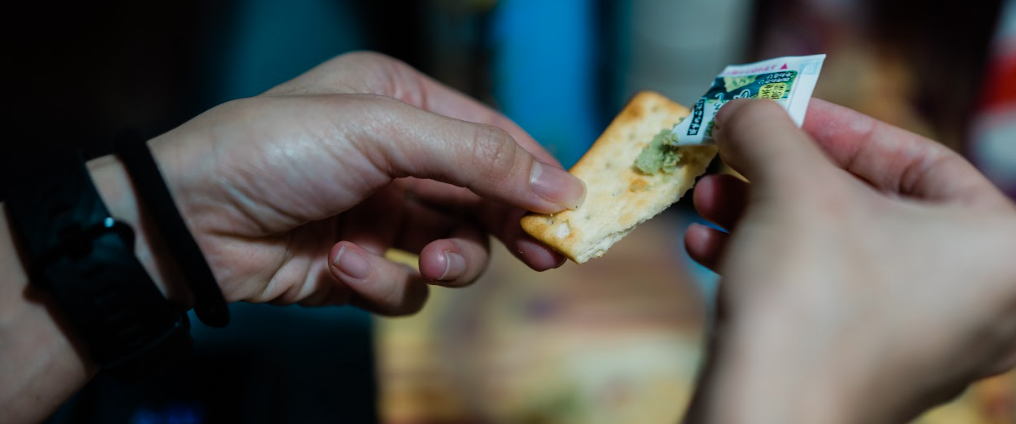 Squeezing wasabi on cracker